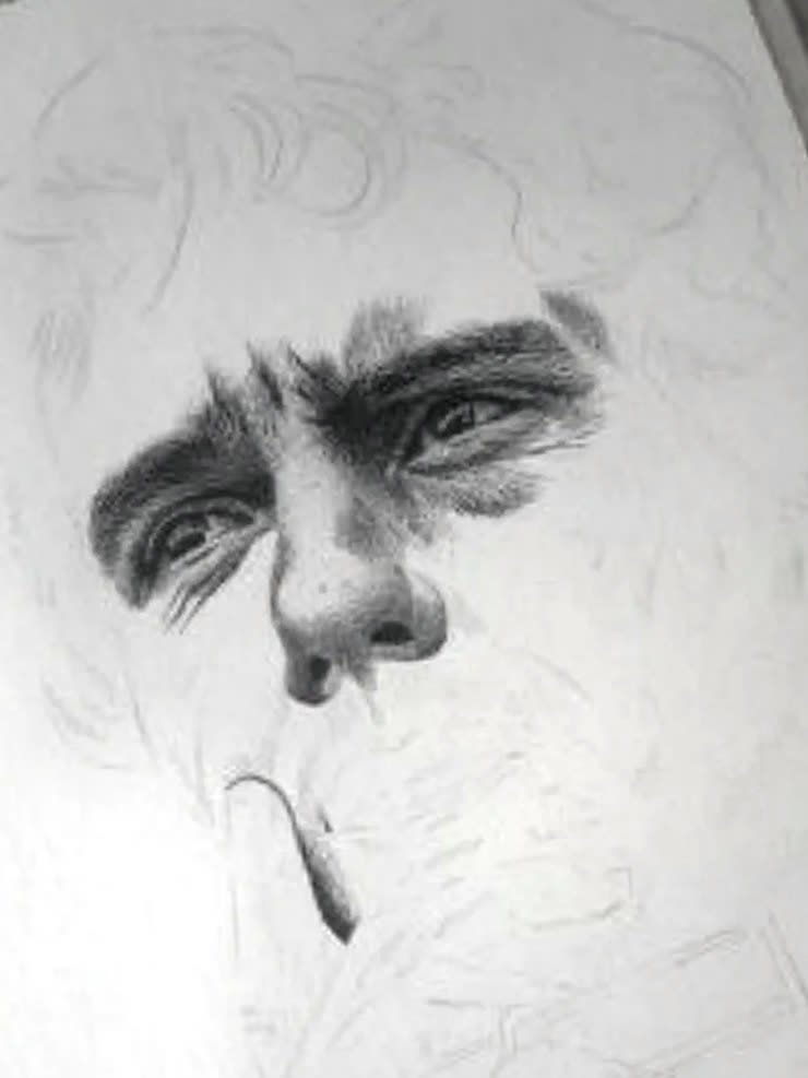 The same portrait at roughly 50 per cent — the face fully rendered in graphite while the rest is still outline